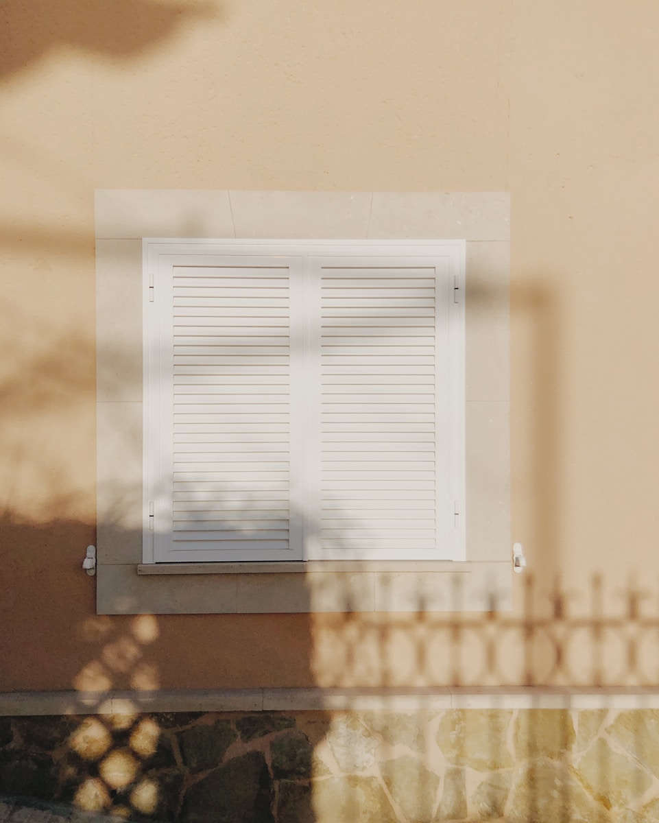 the shadow of a window on the side of a building