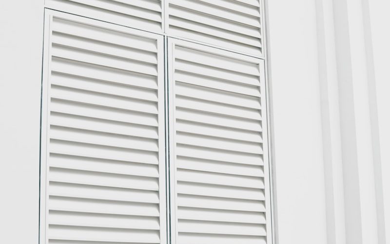 white wooden louvered door