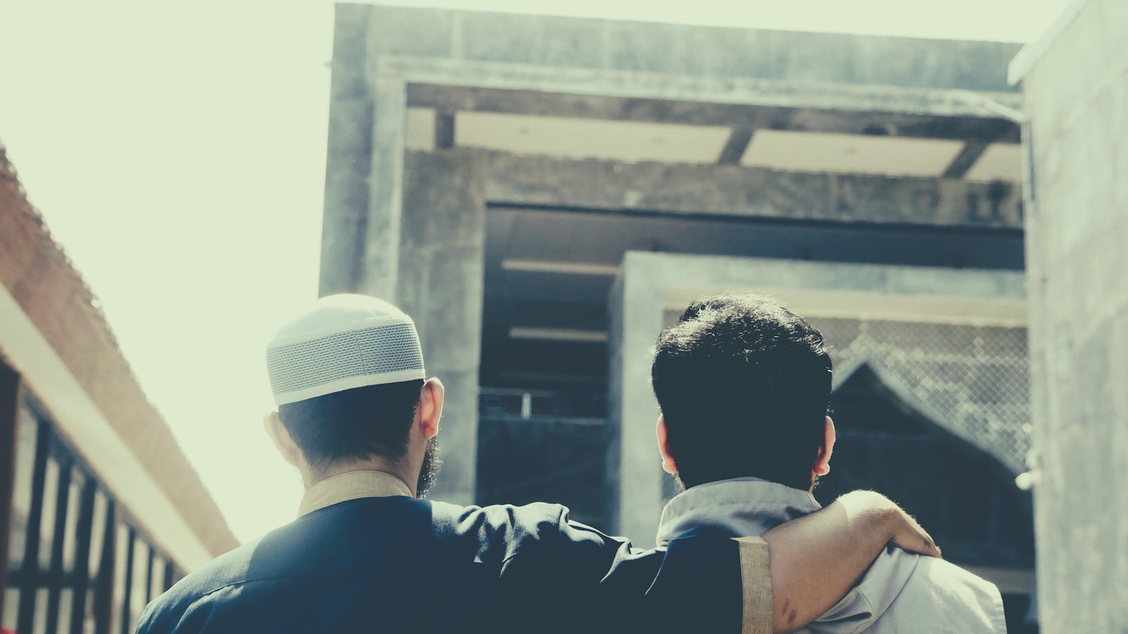 a couple of men looking at a building